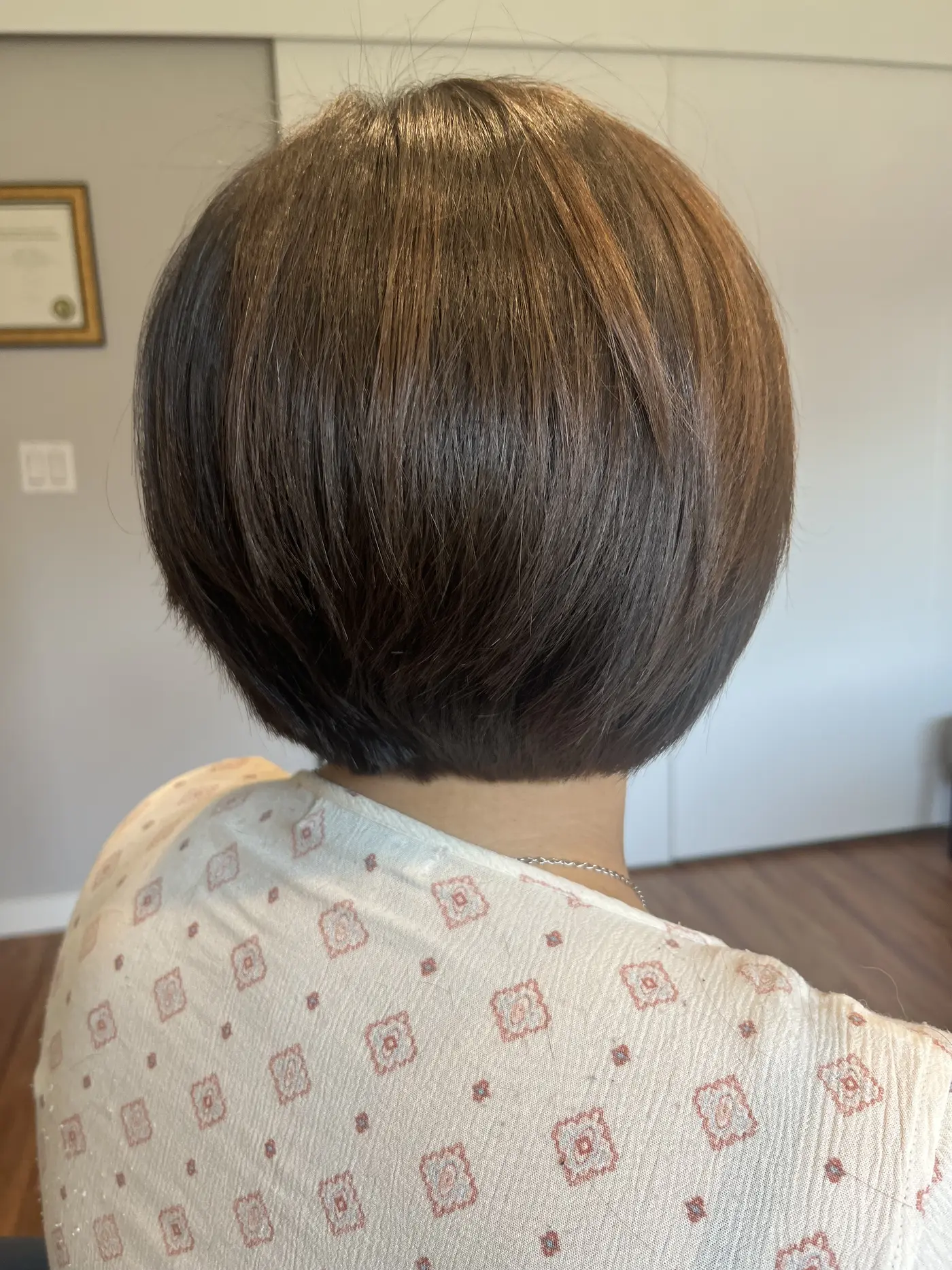Back view of a sleek chin-length bob haircut in dark brown at Zobeida's salon in Kelowna