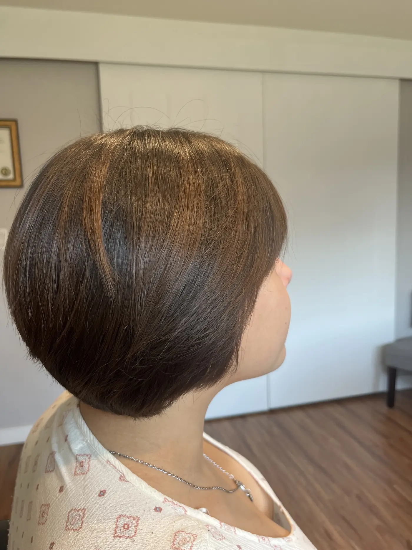 Side view of a short bob haircut with a rounded, blunt finish