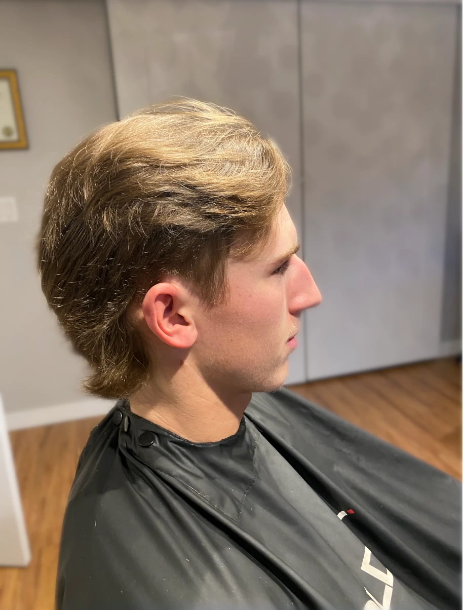 blonde male client with a mullet haircut